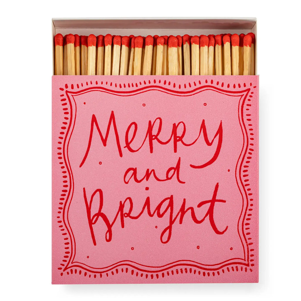 Matchbox with 'Merry and Bright' text on a pink background