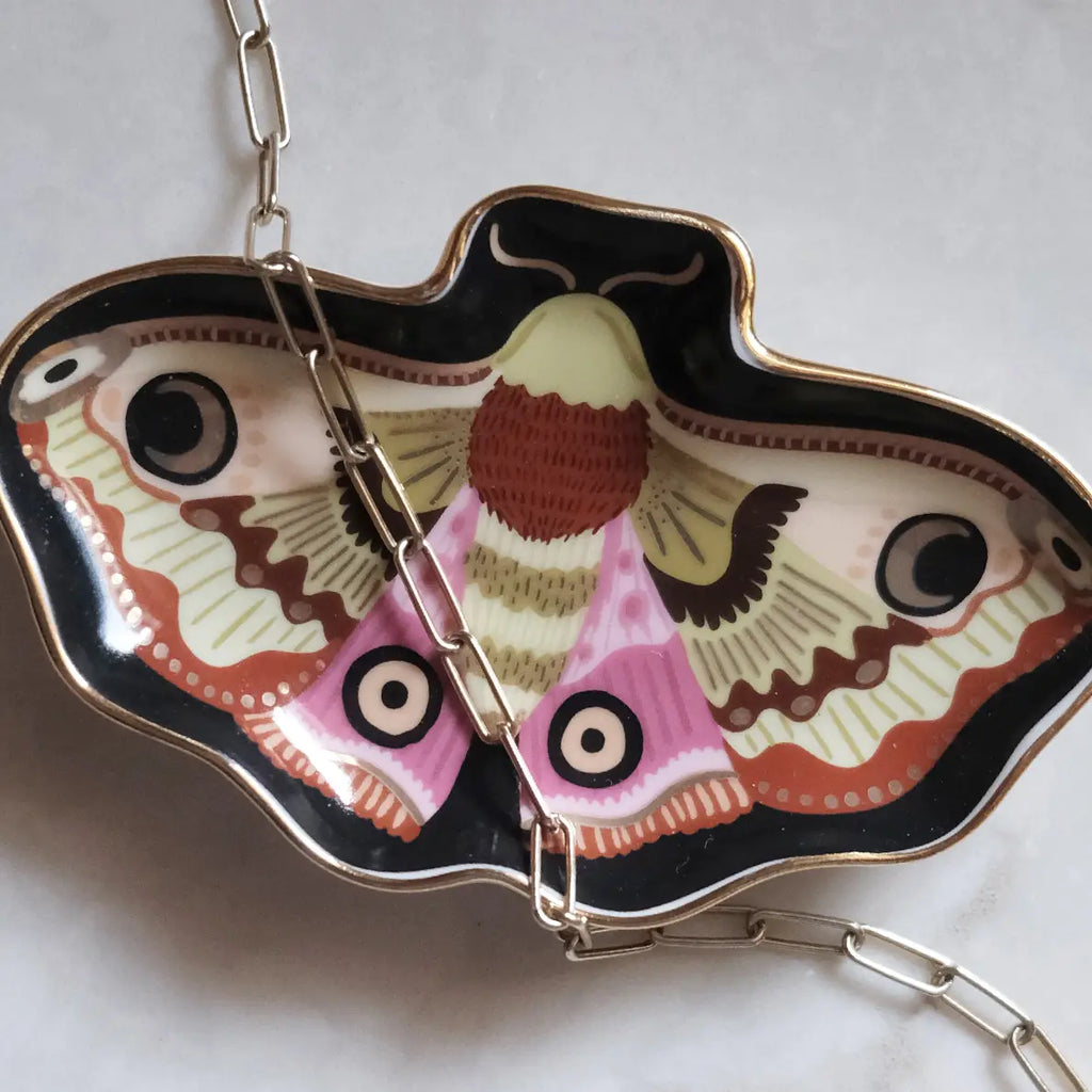 Butterfly-shaped keychain with detailed design on a white background