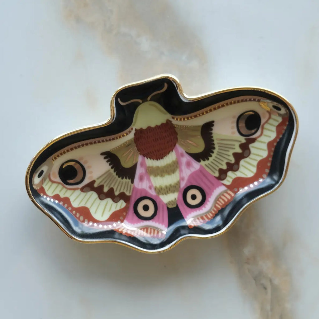 Decorative butterfly-shaped dish with intricate design on a marble surface