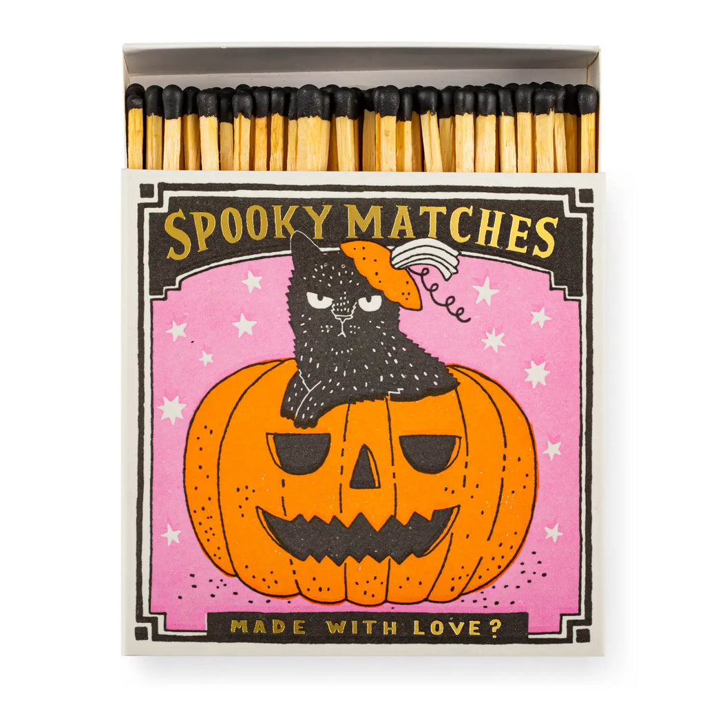 Matches with a Halloween design featuring a black cat on a pumpkin.